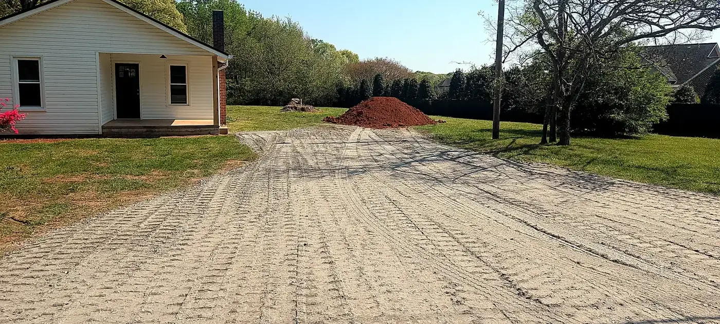 Freshly installed gravel driveway with a shaped and compacted surface services by 3 George's Grading