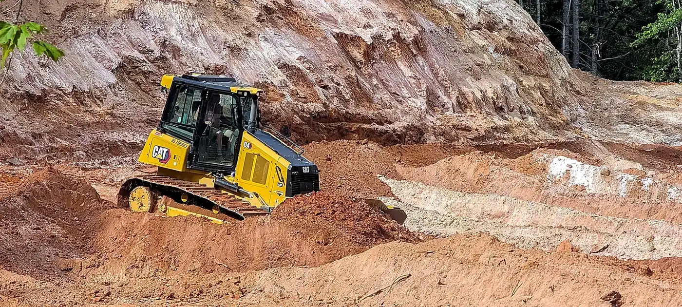Track loader moving and shaping soil on a grading project services by 3 George's Grading